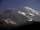 Ecuador Chimborazo 05-03 Estrella del Chimborazo Ventimilla and Whymper Summits At Sunrise Heres a view of the rock band and the glaciers of the Ventimilla (6267m) summit and the main Whymper (6310m) summit of Chimborazo after sunrise viewed from the Estrella del Chimborazo.